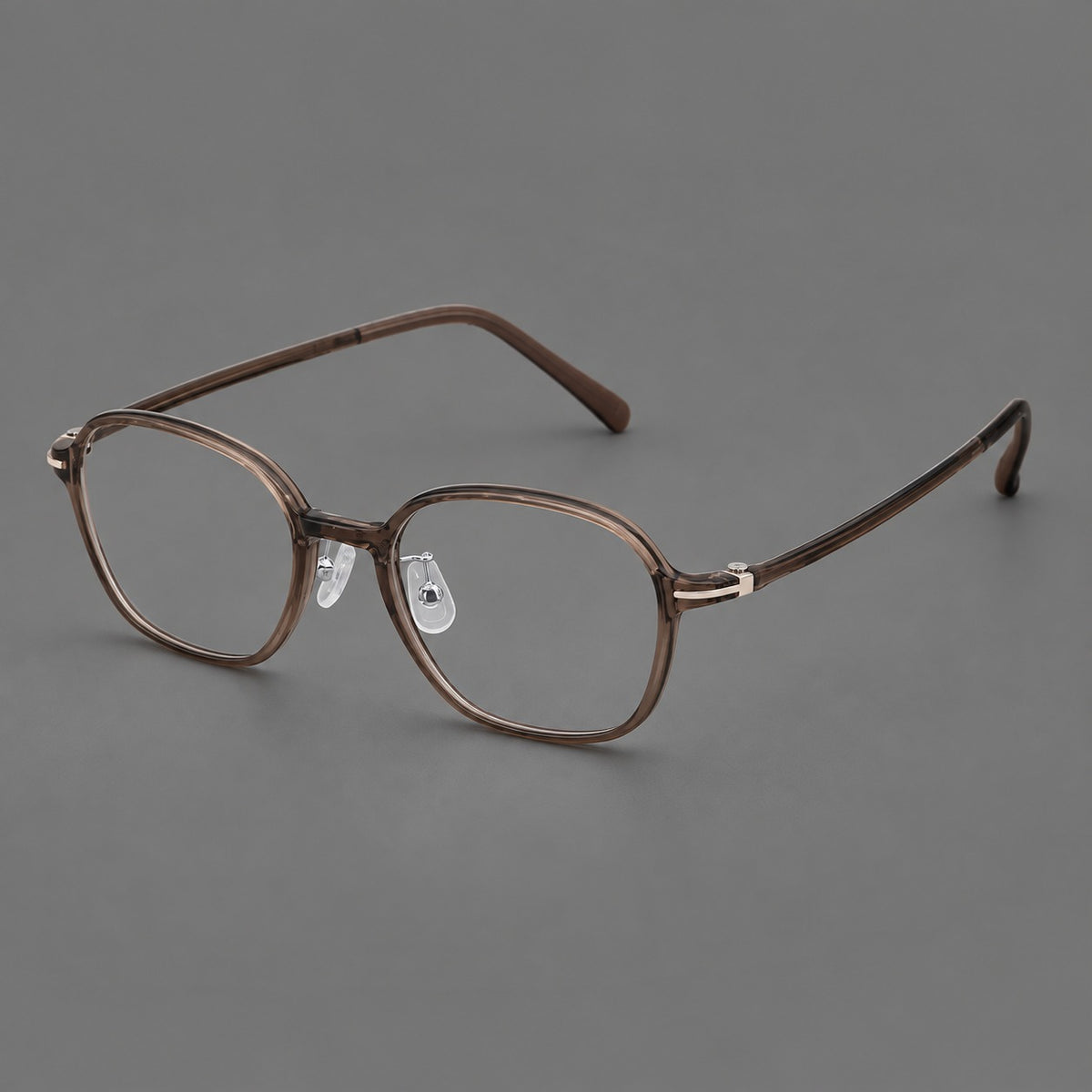 Rounded geometric plastic eyeglasses with softly angled rims and a curved bridge in Ink Brown, three quarter view