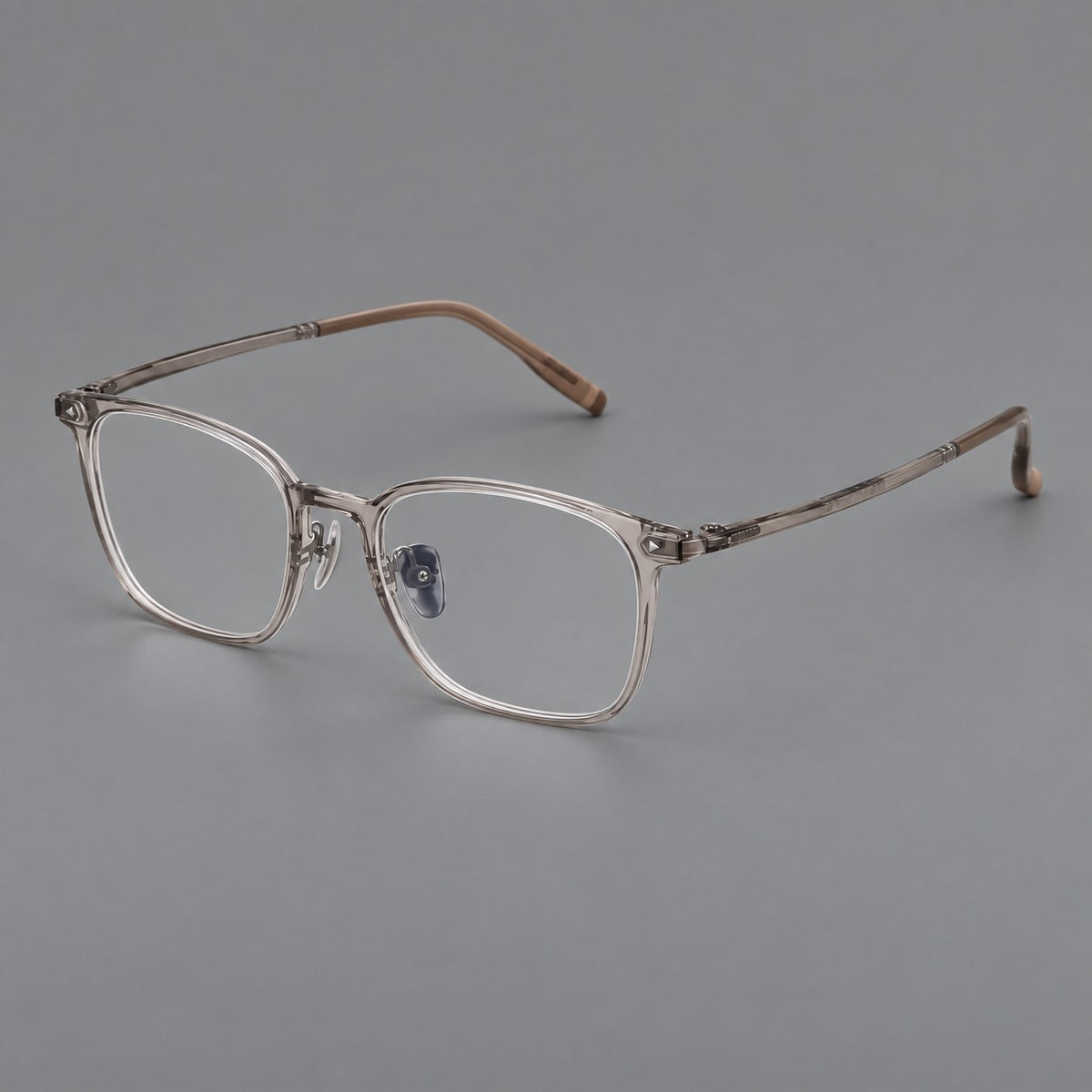 Classic soft square plastic eyeglasses with a gently curved browline and corner studs in Grey Tea, three quarter view