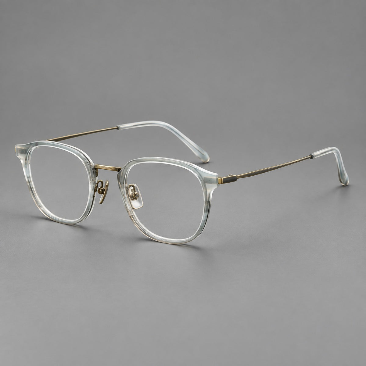 Retro soft square eyeglasses in acetate and titanium with a curved bridge and slender temples in Ice Grey Tortoiseshell / Antique Gold, three quarter view