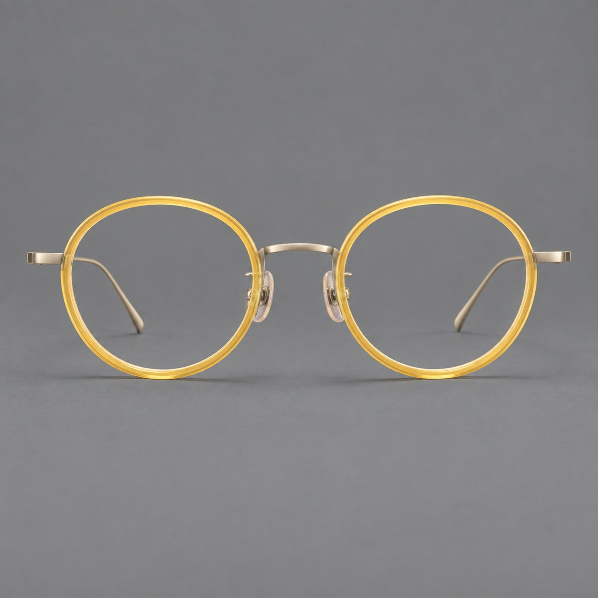 Classic round eyeglasses in acetate and titanium with slim rims and textured metal temples in Lemon Yellow / Gold, front view