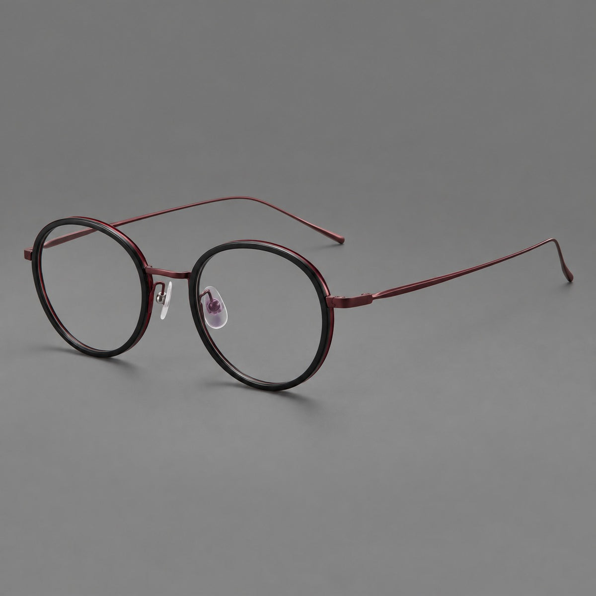 Classic round eyeglasses in acetate and titanium with slim rims and textured metal temples in Glossy Black / Wine Red, three quarter view
