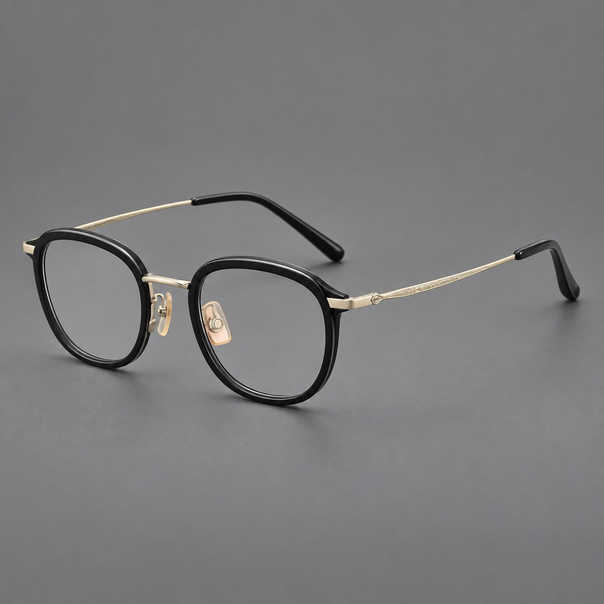 Soft square eyeglasses in acetate and titanium with rounded corners and decorative metal temples in Matte Black / Light Gold, three quarter view