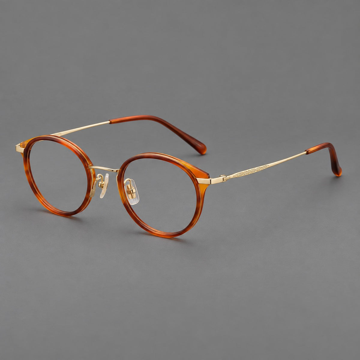 Retro panto eyeglasses in acetate and titanium with an arched bridge and engraved metal temples in Amber Tortoiseshell / Light Gold, three quarter view