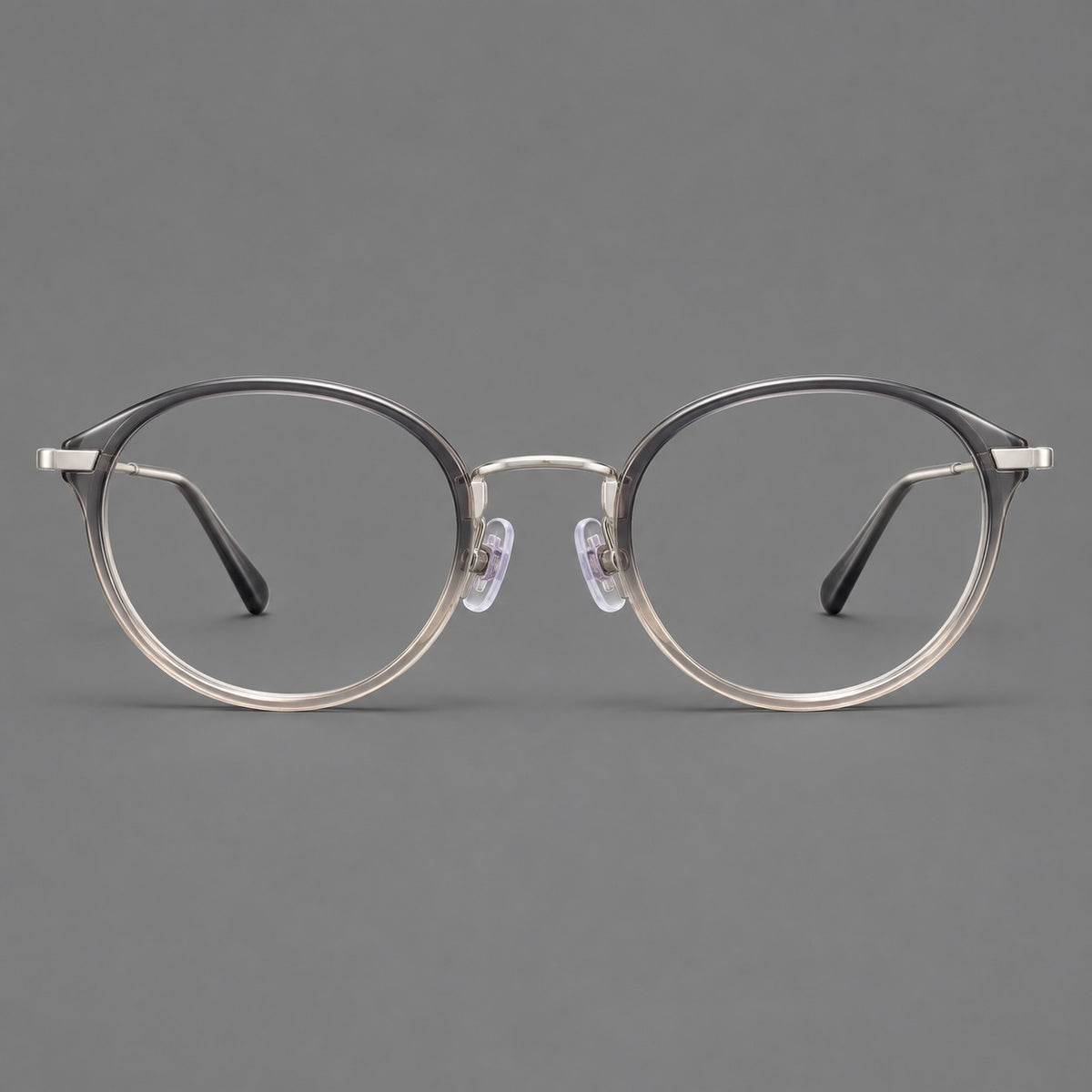 Retro panto eyeglasses in acetate and titanium with an arched bridge and engraved metal temples in Grey Green Gradient / Silver, front view