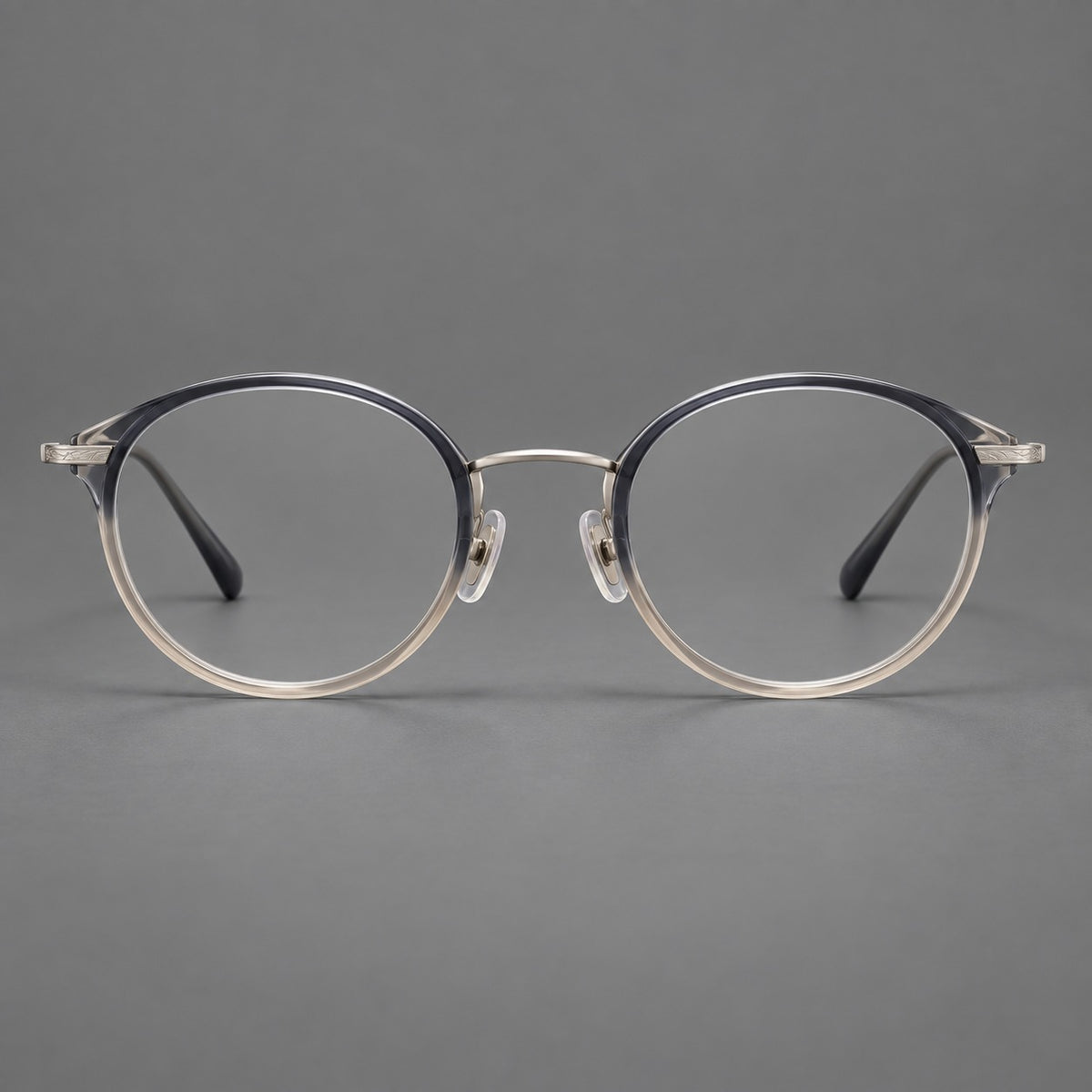 Retro panto eyeglasses in acetate and titanium with an arched bridge and engraved metal temples in Grey Blue Tea Gradient / Light Gunmetal, front view