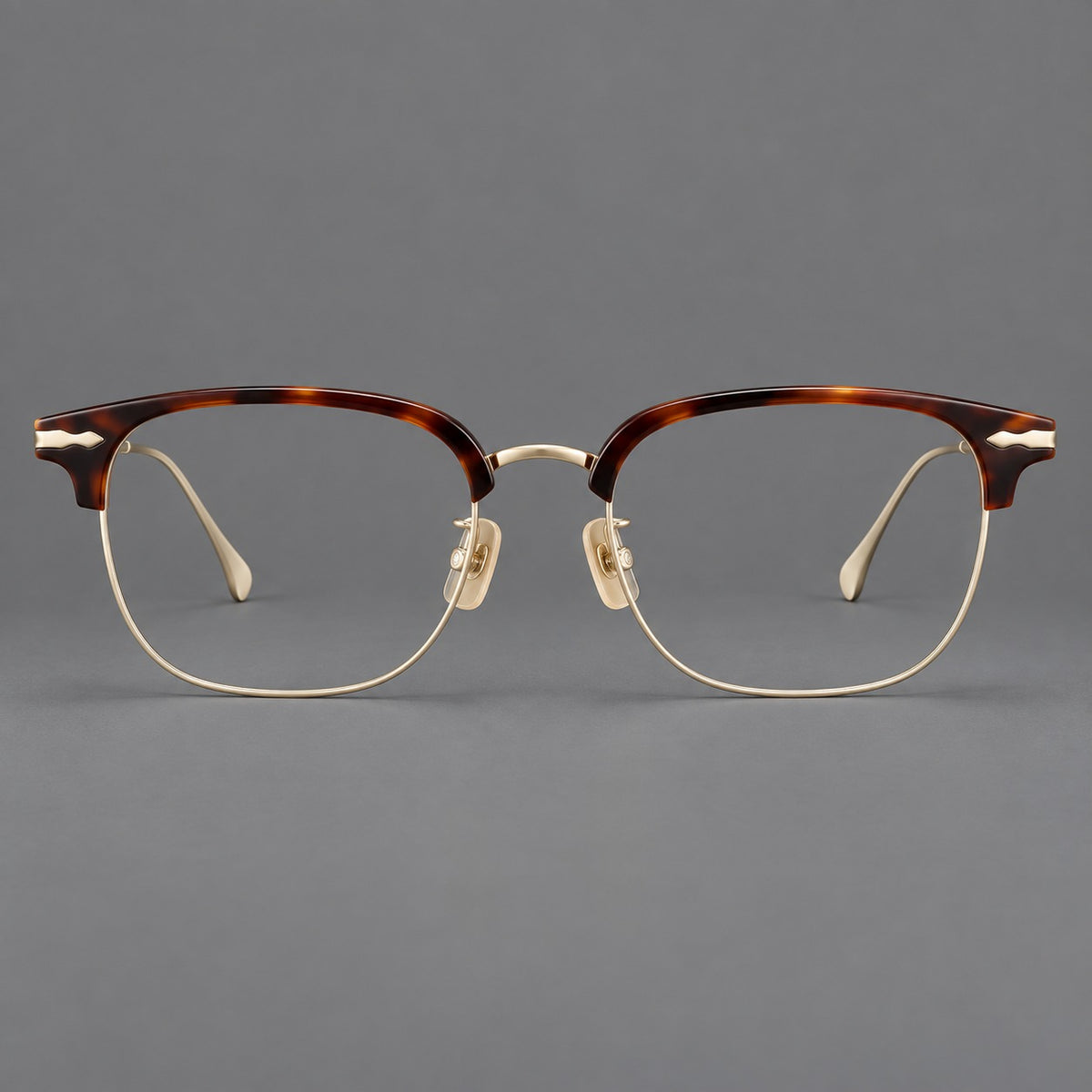 Browline eyeglasses in acetate and titanium with slim metal lower rims and decorative corners in Tortoiseshell / Gold, front view