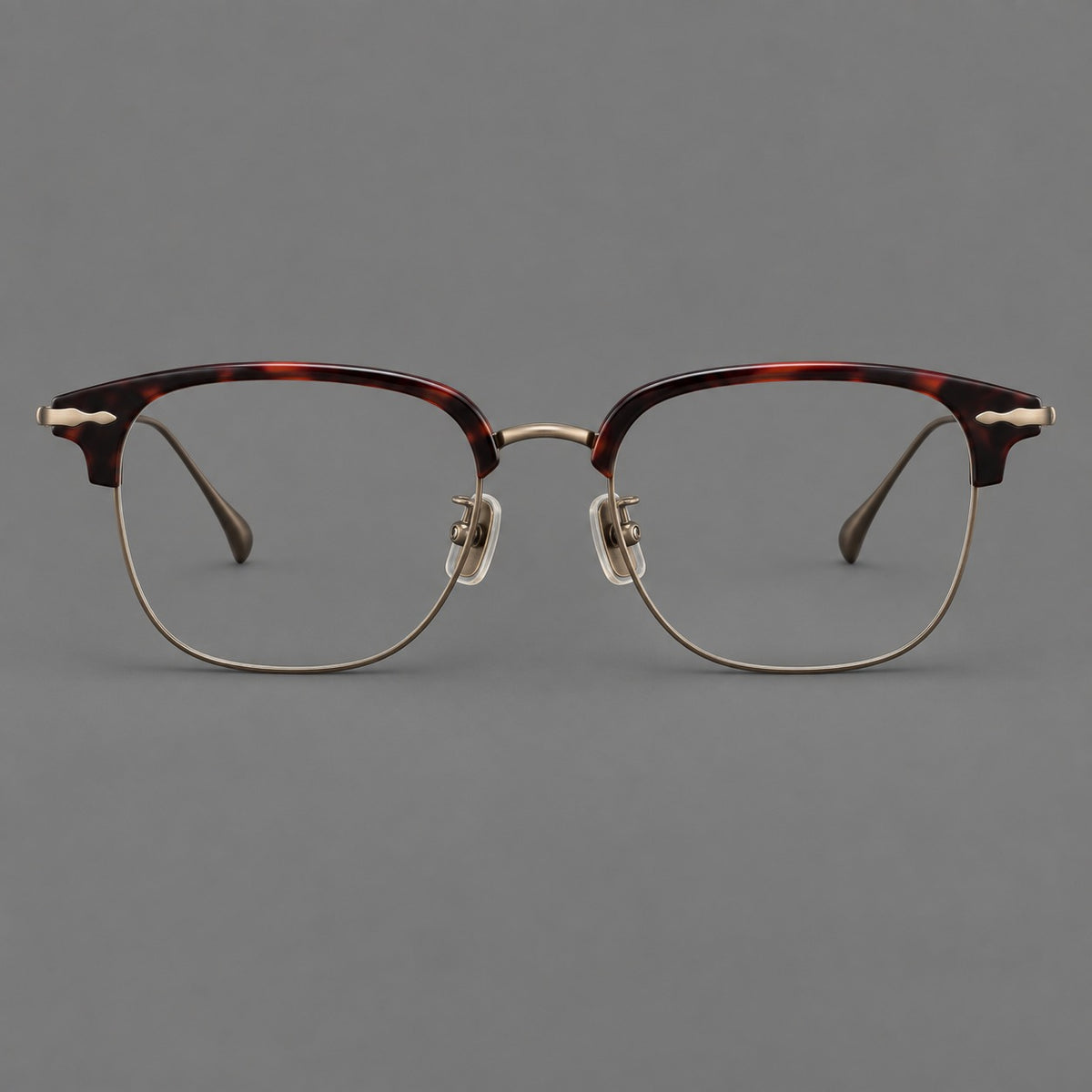 Browline eyeglasses in acetate and titanium with slim metal lower rims and decorative corners in Red Tortoiseshell / Antique Bronze, front view