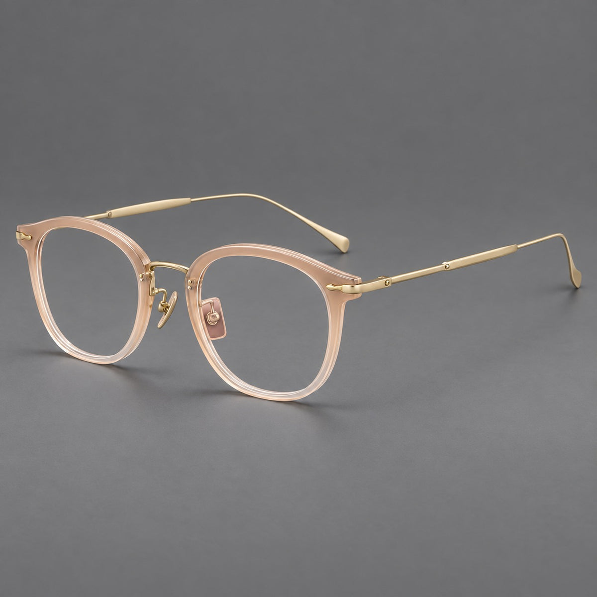 Panto eyeglasses in acetate and titanium with curved brows and decorative metal corner accents in Nude Pink / Gold, three quarter view