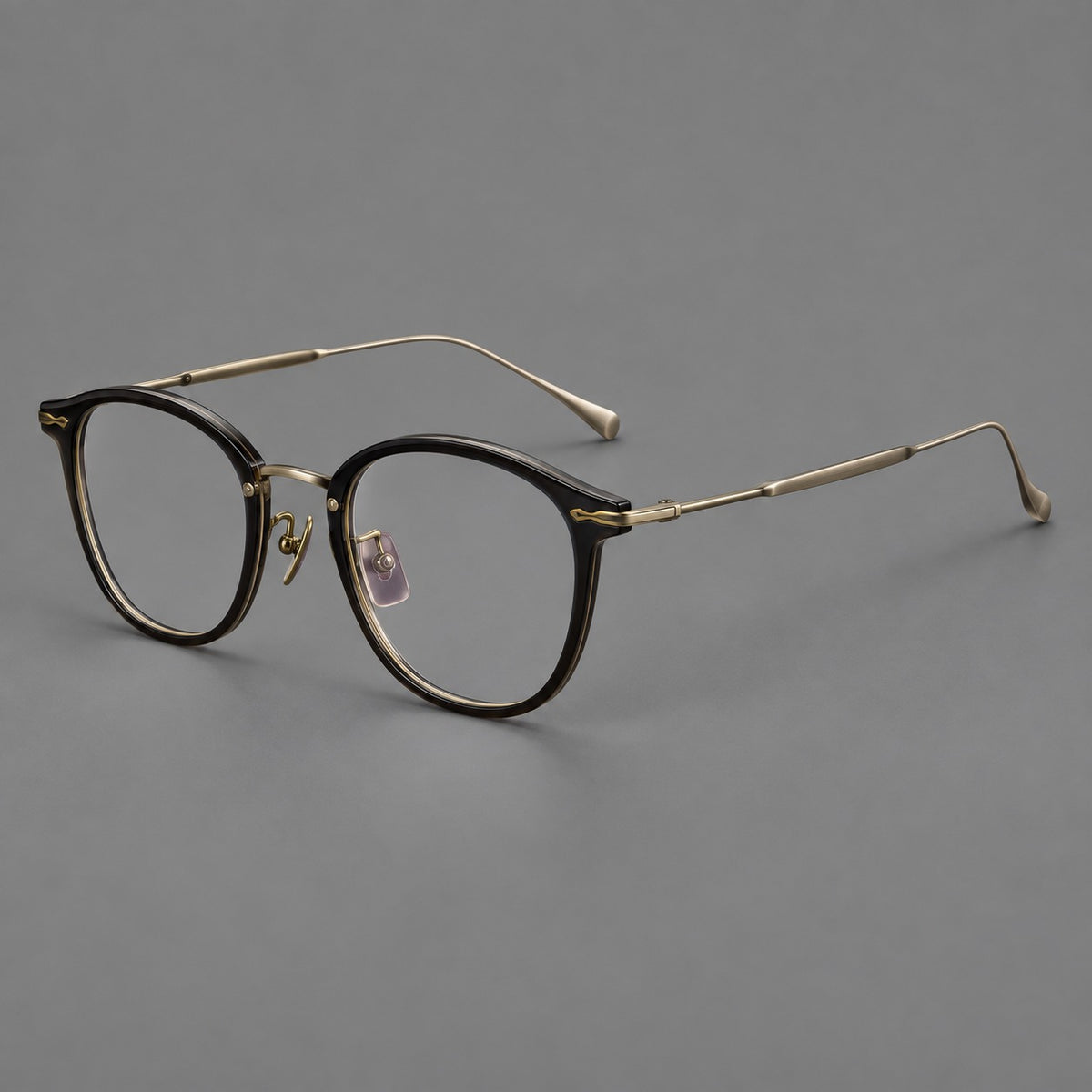 Panto eyeglasses in acetate and titanium with curved brows and decorative metal corner accents in Glossy Black / Antique Bronze, three quarter view