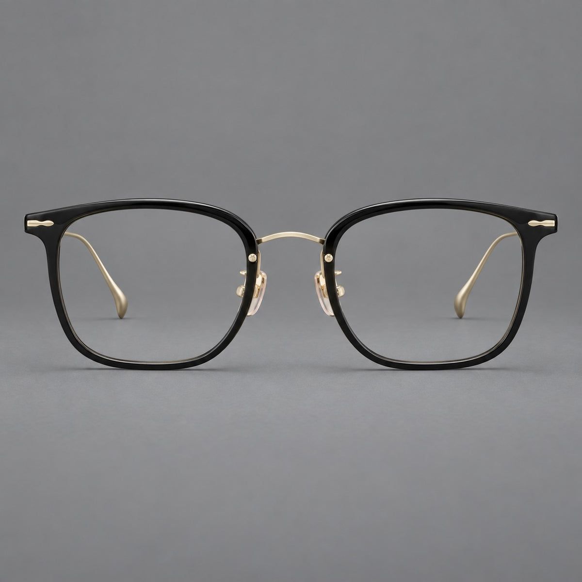 Retro square eyeglasses in acetate and titanium with rounded edges and sculpted corner accents in Glossy Black / Gold, front view