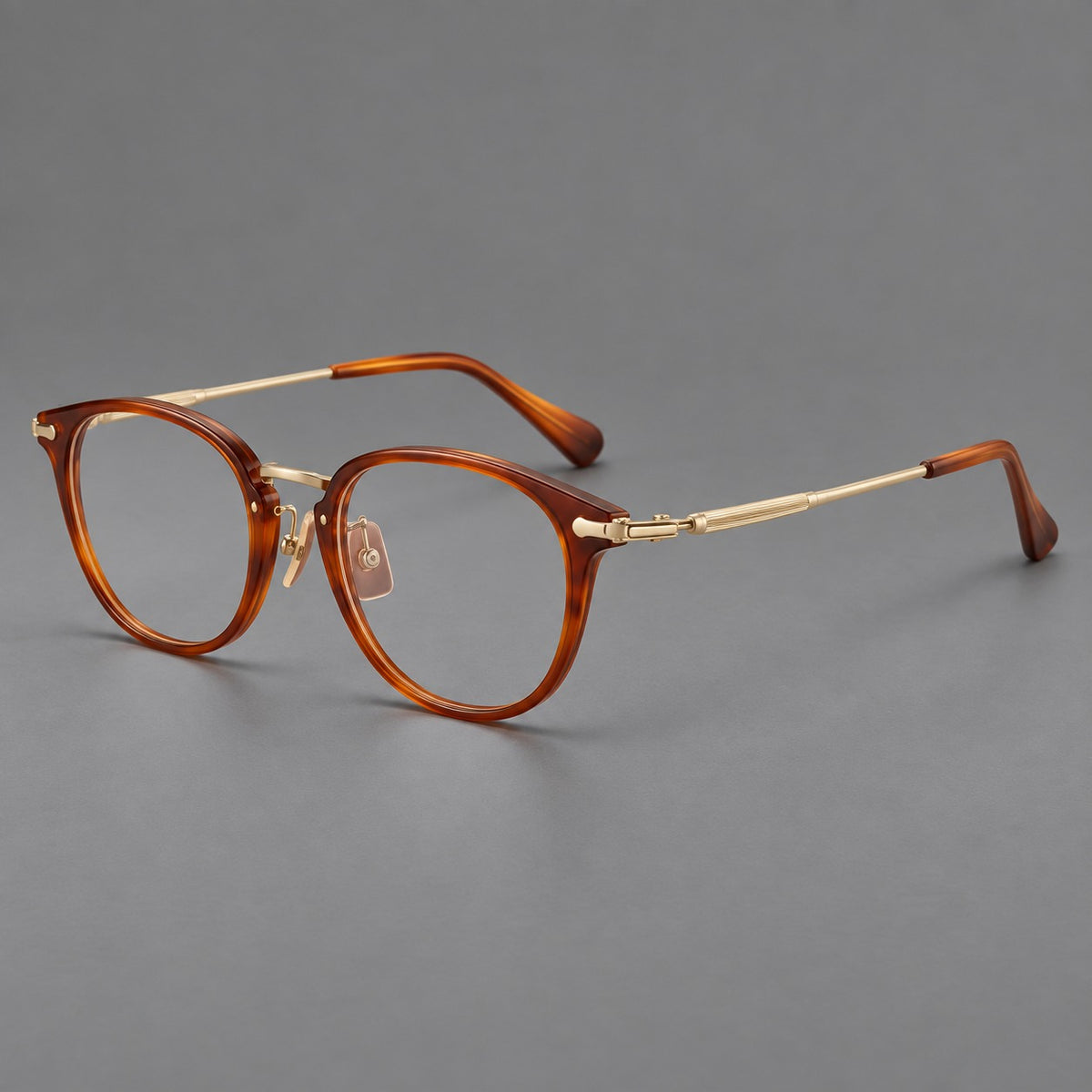 Classic soft square eyeglasses in acetate and titanium with engraved temples and corner accents in Amber Tortoiseshell / Gold, three quarter view