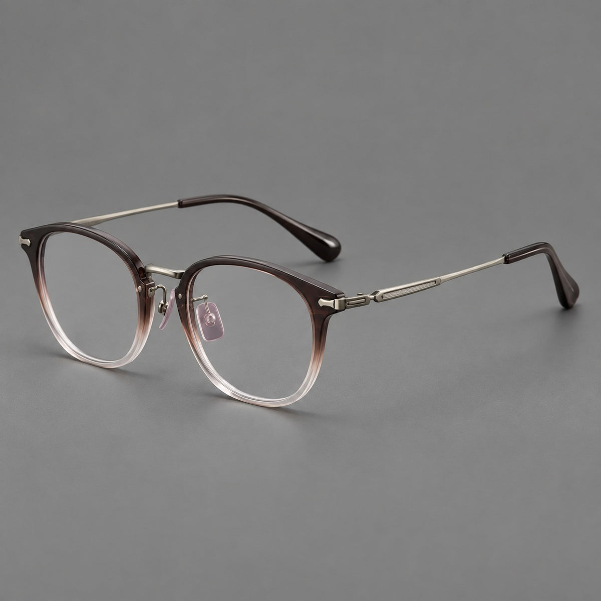 Classic soft square eyeglasses in acetate and titanium with engraved temples and corner accents in Tea Brown Gradient / Dark Grey, three quarter view