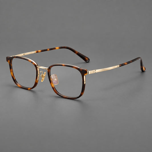 Rounded rectangular eyeglasses in acetate and titanium with bold corners and engraved metal temples in Tortoiseshell / Gold, three quarter view