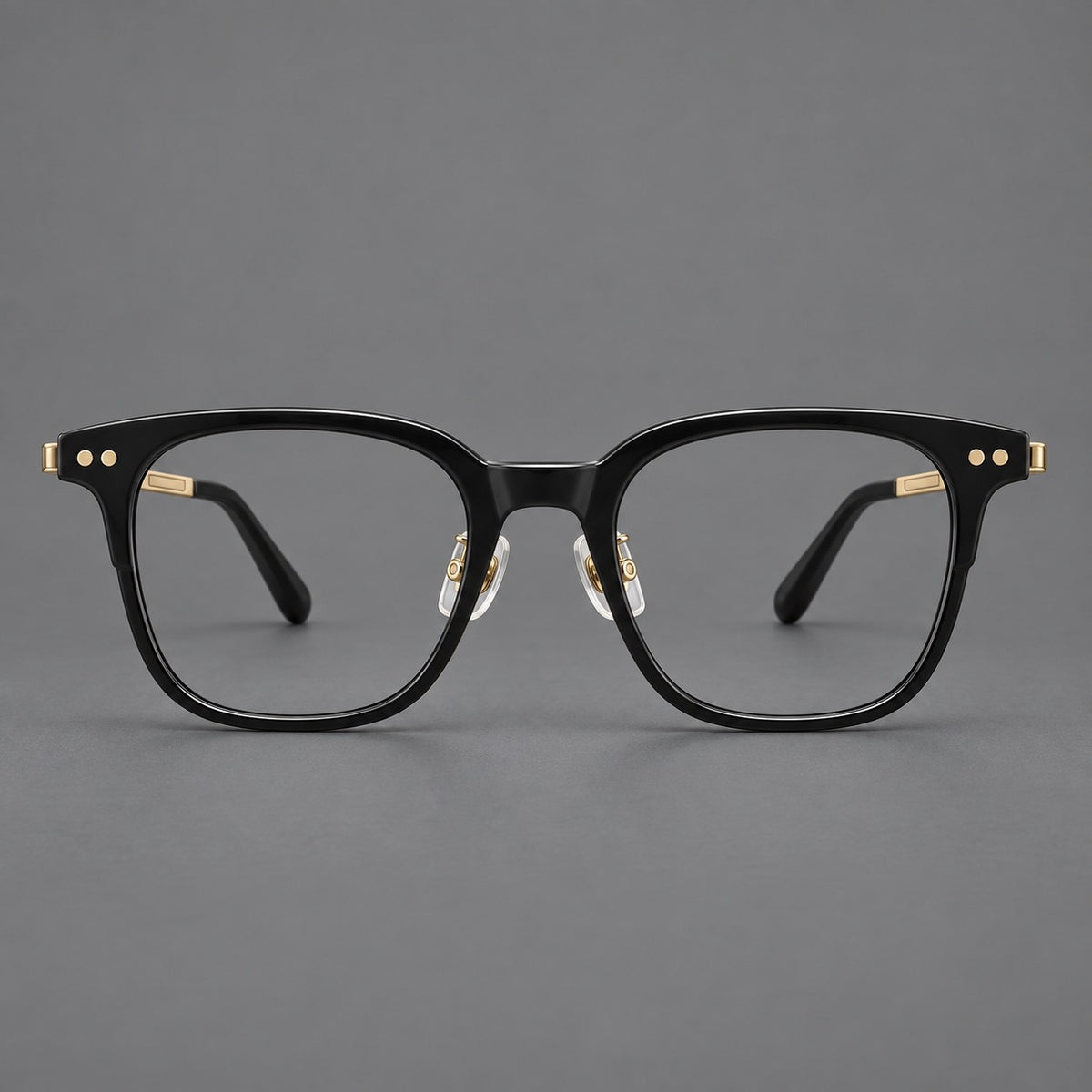Classic acetate and titanium eyeglasses with squared brows and paired corner rivets in Black / Gold, front view