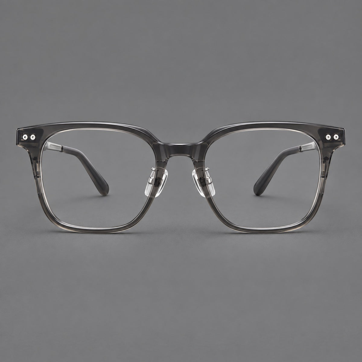 Classic acetate and titanium eyeglasses with squared brows and paired corner rivets in Clear Grey / Silver, front view