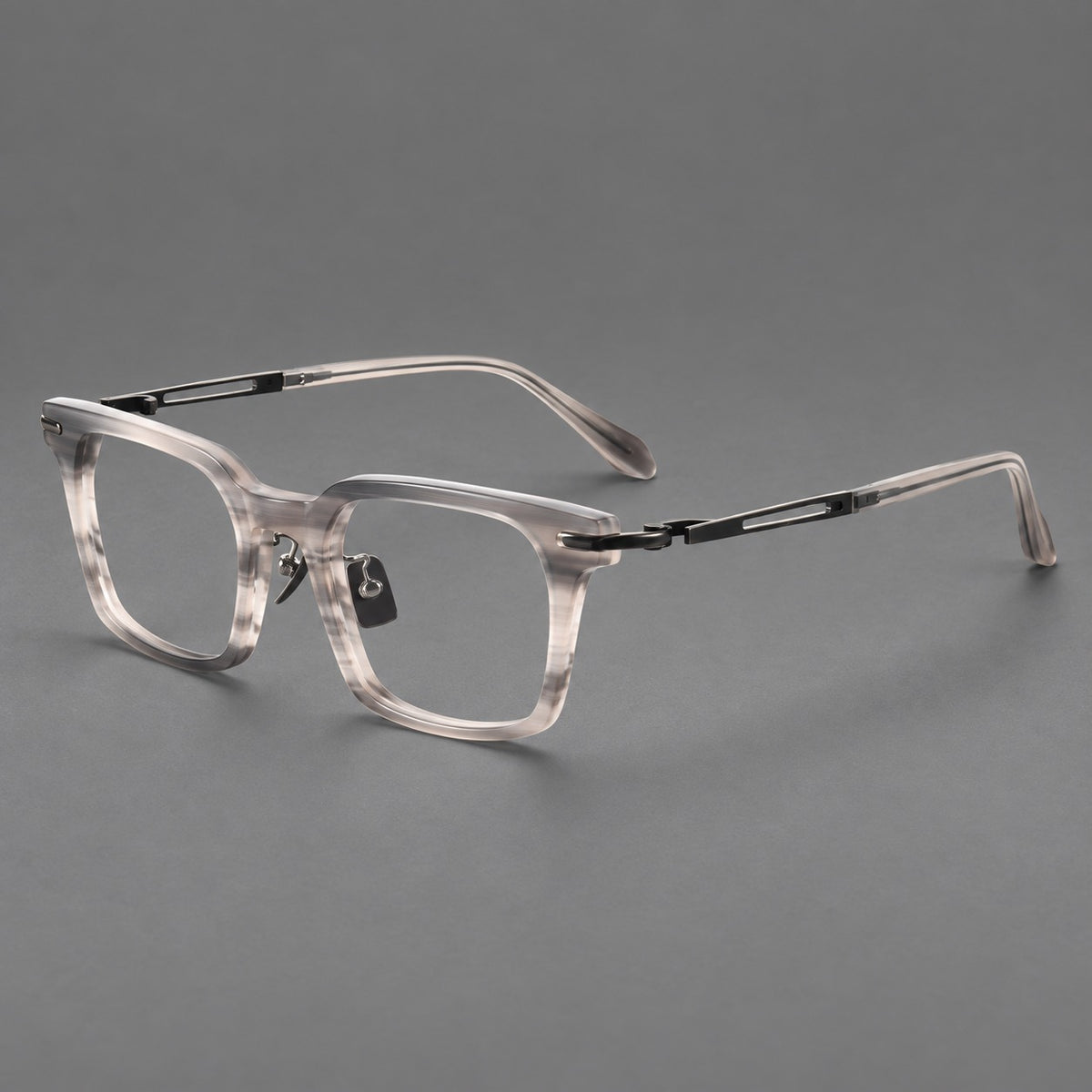Modern acetate and titanium eyeglasses with angular square rims and curved metal hinges in Striped Grey / Brushed Grey, three quarter view