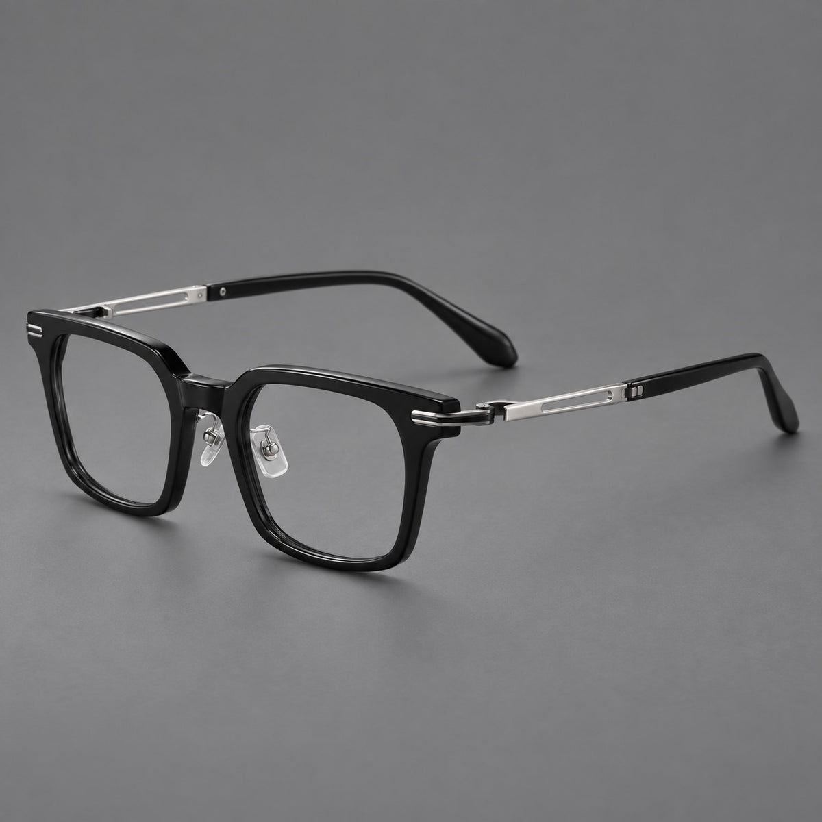 Modern acetate and titanium eyeglasses with angular square rims and curved metal hinges in Black / Silver, three quarter view