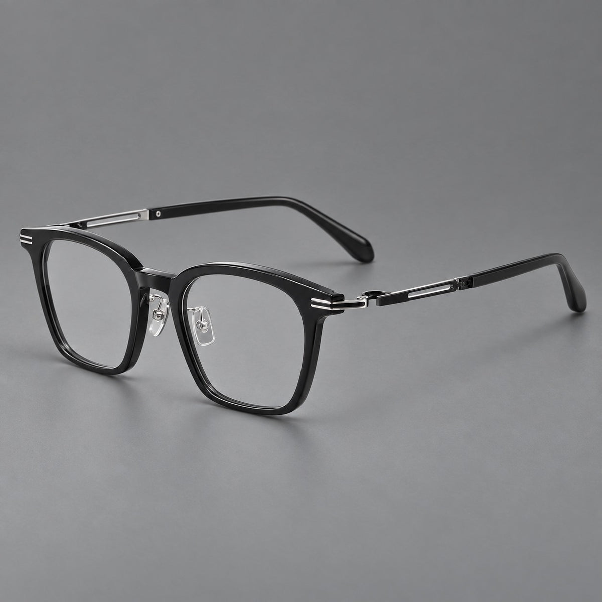 Acetate and titanium eyeglasses with rounded rectangular rims and sculpted open loop joints in Black / Silver, three quarter view