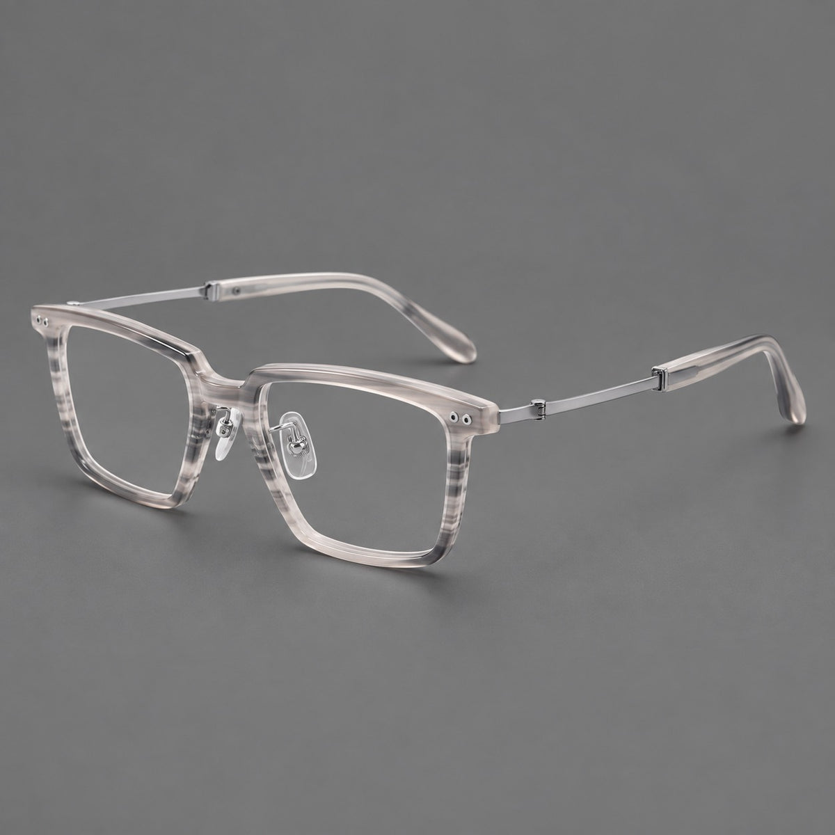 Classic acetate and titanium eyeglasses with a straight brow and rounded rectangular rims in Striped Grey / Silver, three quarter view