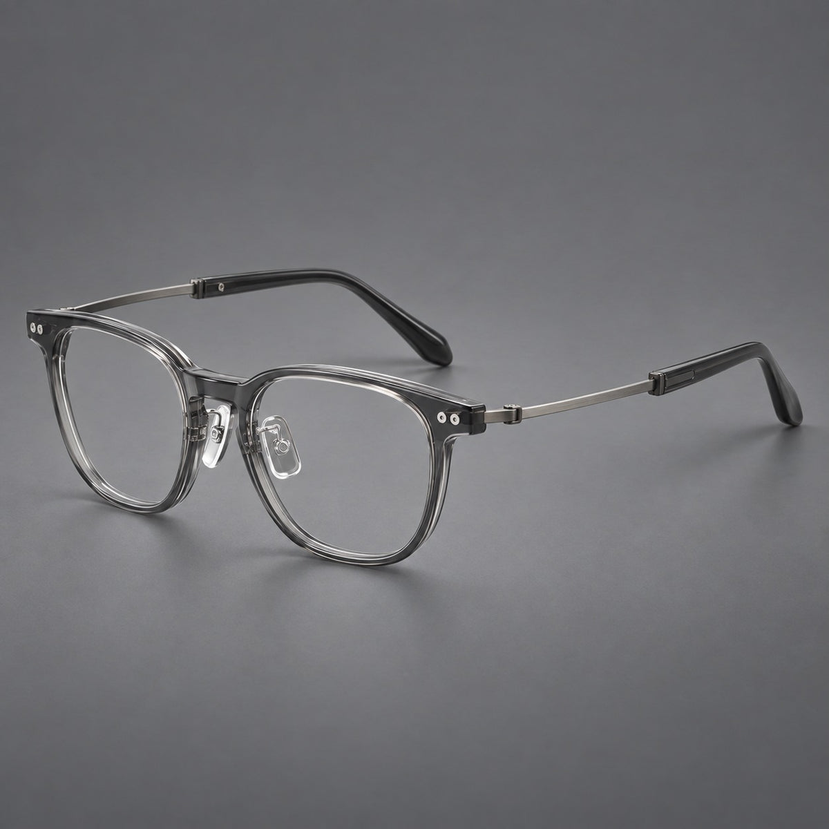 Vintage acetate and titanium eyeglasses with soft square rims and paired metal rivets in Clear Grey / Brushed Grey, three quarter view