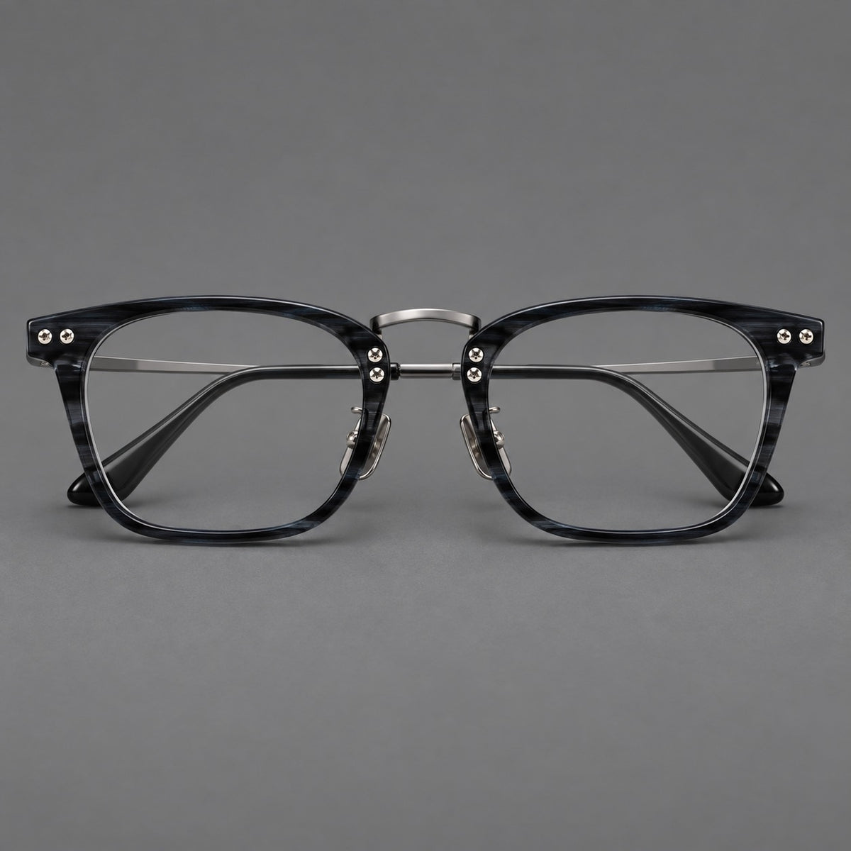 Acetate and titanium eyeglasses with angular rectangular rims and a curved metal bridge in Grey Blue Woodgrain / Gunmetal, front view