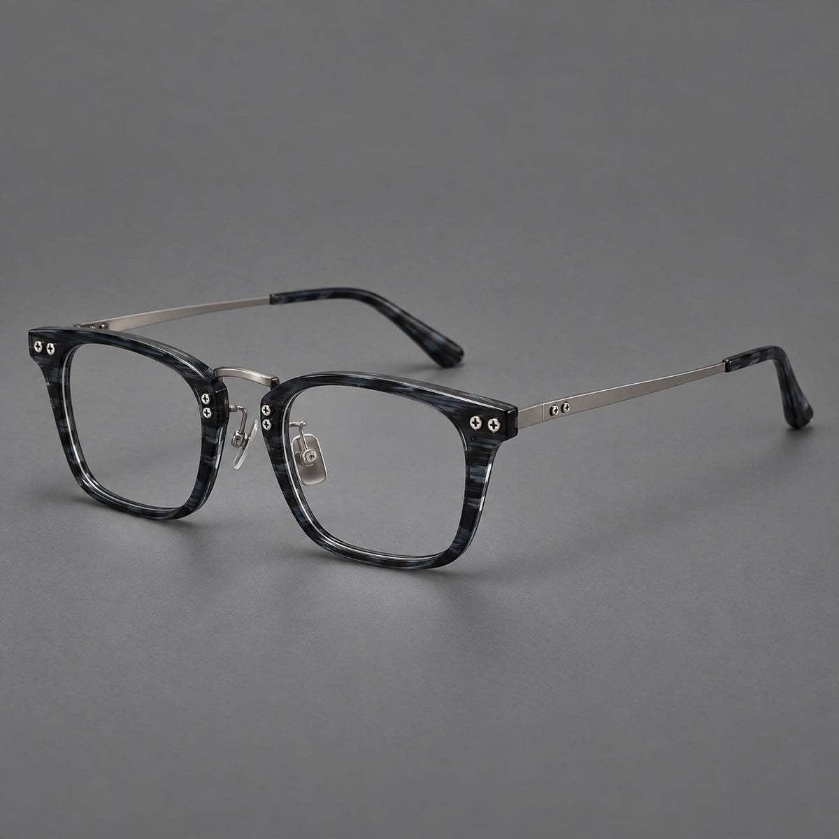 Acetate and titanium eyeglasses with angular rectangular rims and a curved metal bridge in Grey Blue Woodgrain / Gunmetal, three quarter view