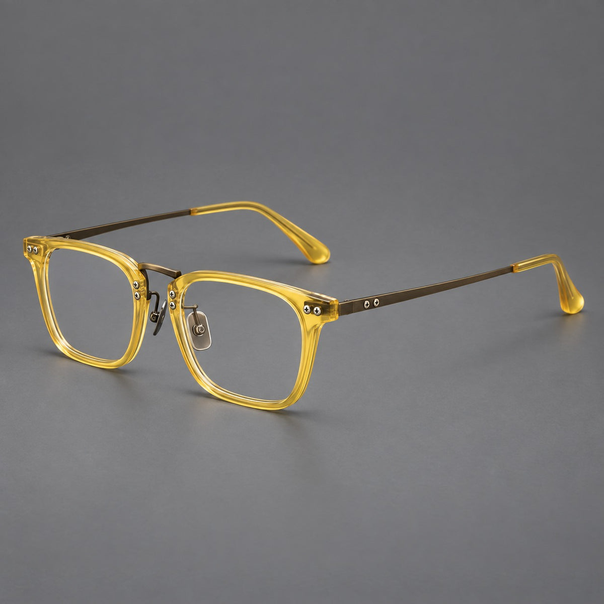 Acetate and titanium eyeglasses with angular rectangular rims and a curved metal bridge in Jade Yellow / Antique Bronze, three quarter view