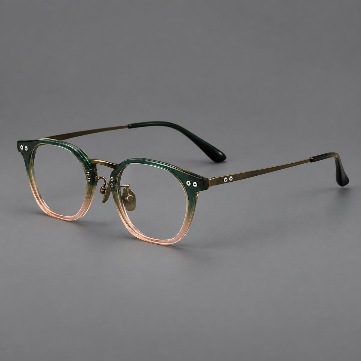 Retro acetate and titanium eyeglasses with softly rounded rims and a metal bridge in Green Pink Gradient / Antique Bronze, three quarter view