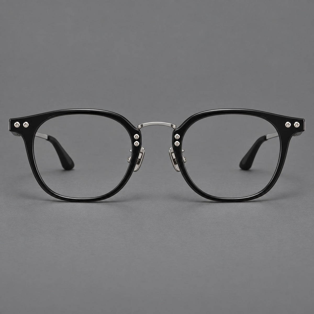 Retro acetate and titanium eyeglasses with softly rounded rims and a metal bridge in Black / Silver, front view