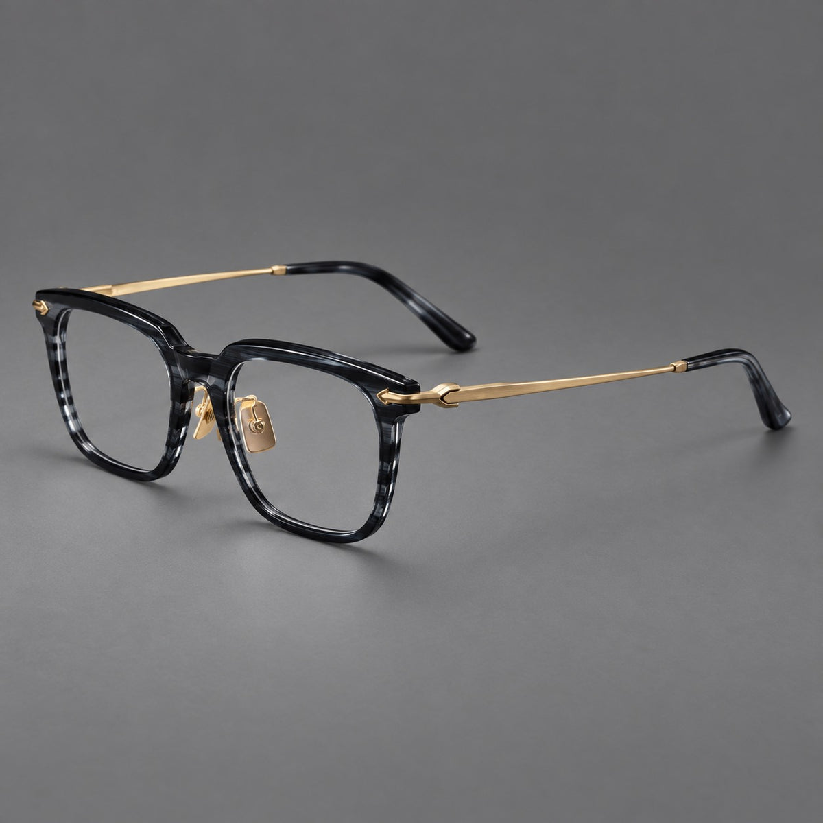 Bold acetate and titanium eyeglasses with rectangular rims and sculpted arrow accents in Grey Blue Woodgrain / Light Gold, three quarter view