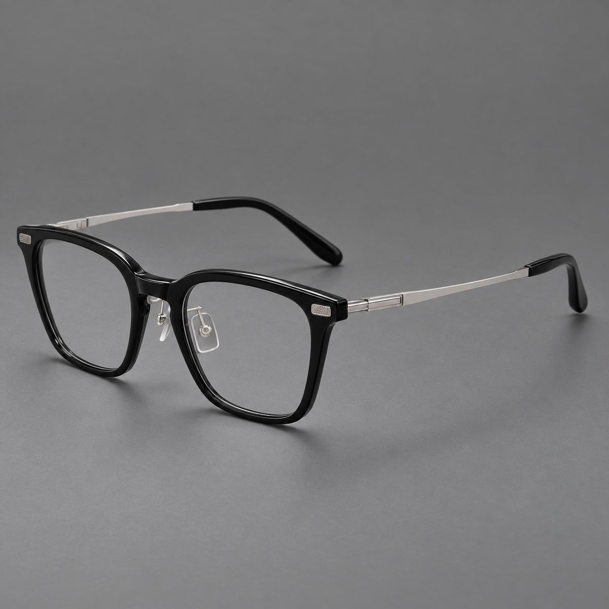 Classic acetate and titanium eyeglasses with rounded square rims and textured corner accents in Black / Silver, three quarter view