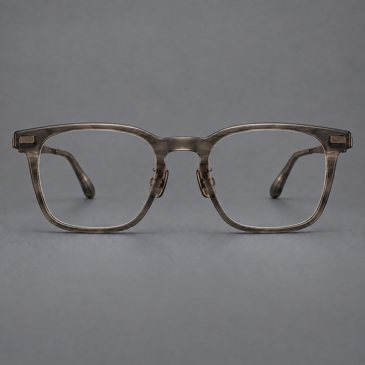 Classic acetate and titanium eyeglasses with rounded square rims and textured corner accents in Dark Grey / Antique Bronze, front view