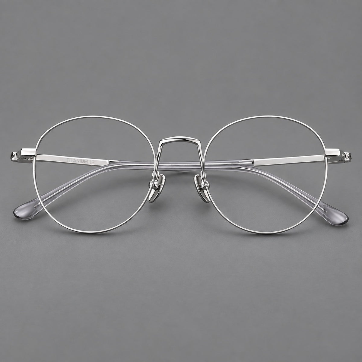 Retro round titanium glasses with a raised bridge and smooth corner shoulders in Silver, front view