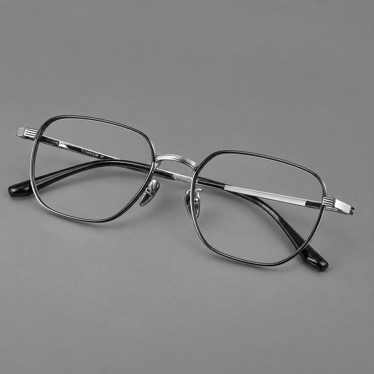 Retro square titanium glasses with rounded rims and finely grooved shoulders in Black and Silver, three quarter view