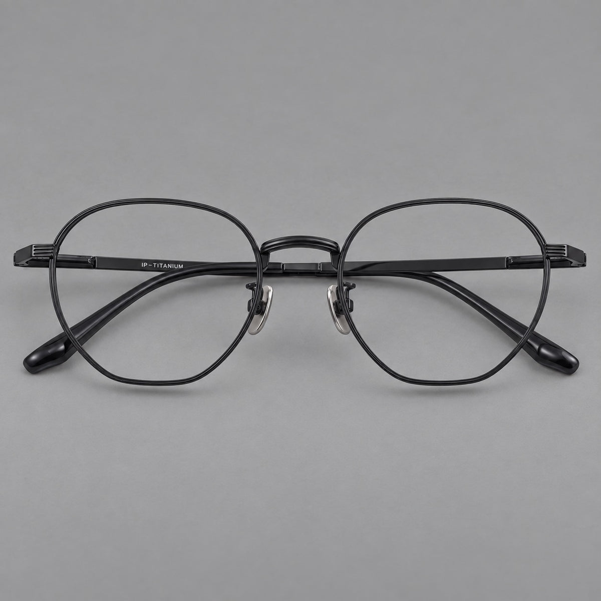 Retro panto titanium glasses with a curved bridge and fine parallel rim grooves in Black, front view