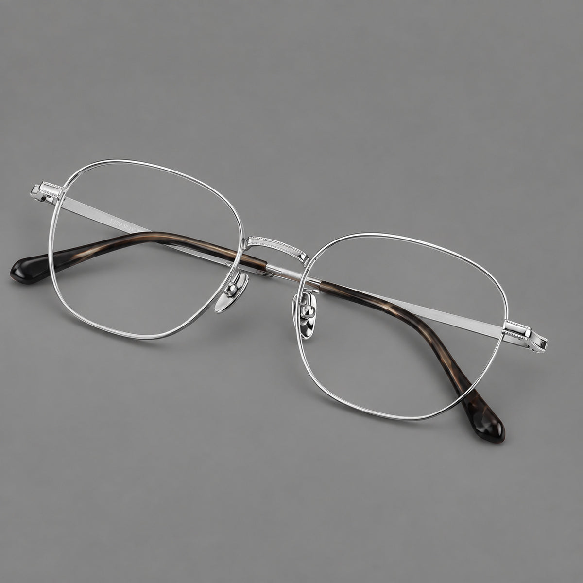 Retro panto titanium glasses with stepped corners and finely engraved temples in Silver, three quarter view