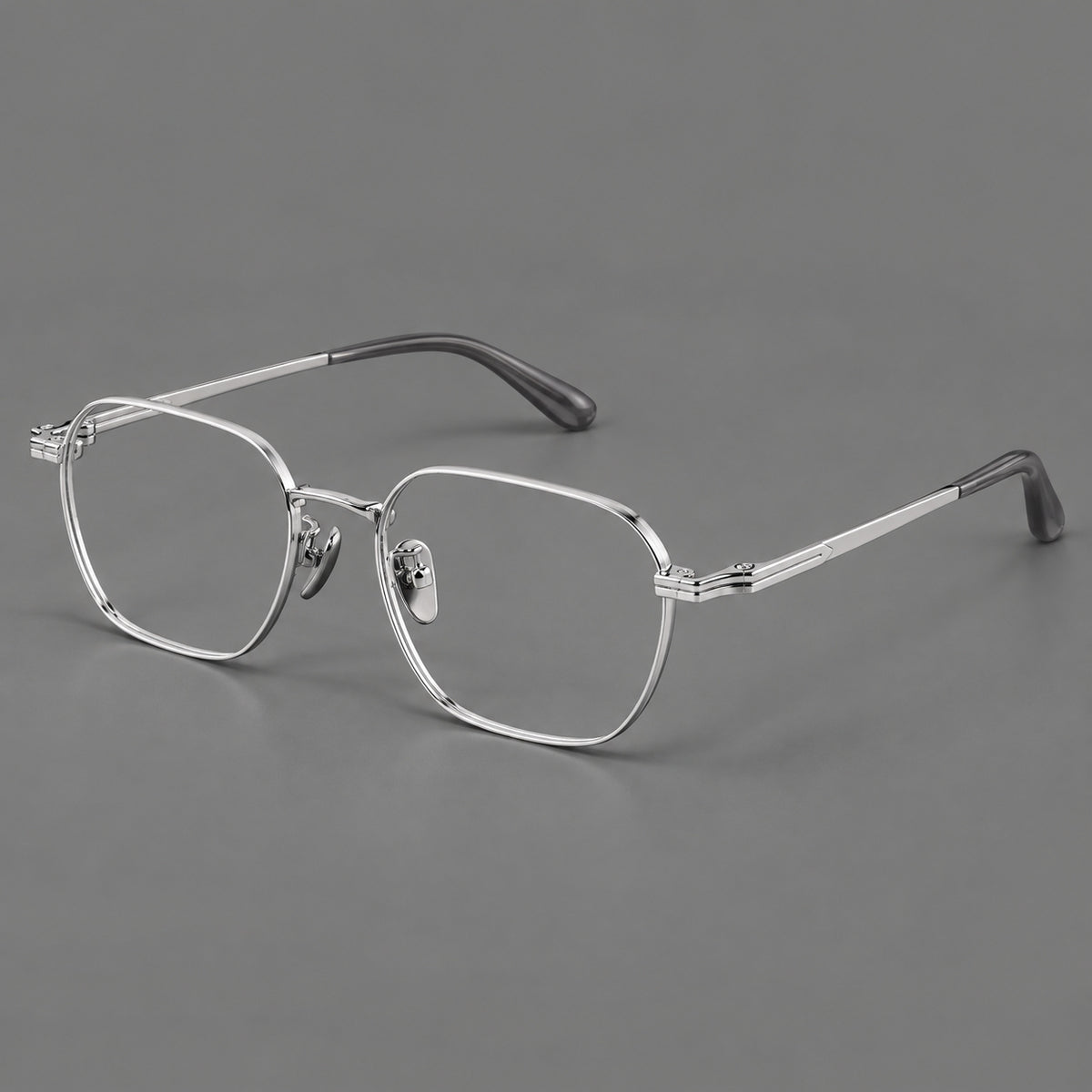 Soft square titanium glasses with an angular bridge and layered corner details in Silver, three quarter view