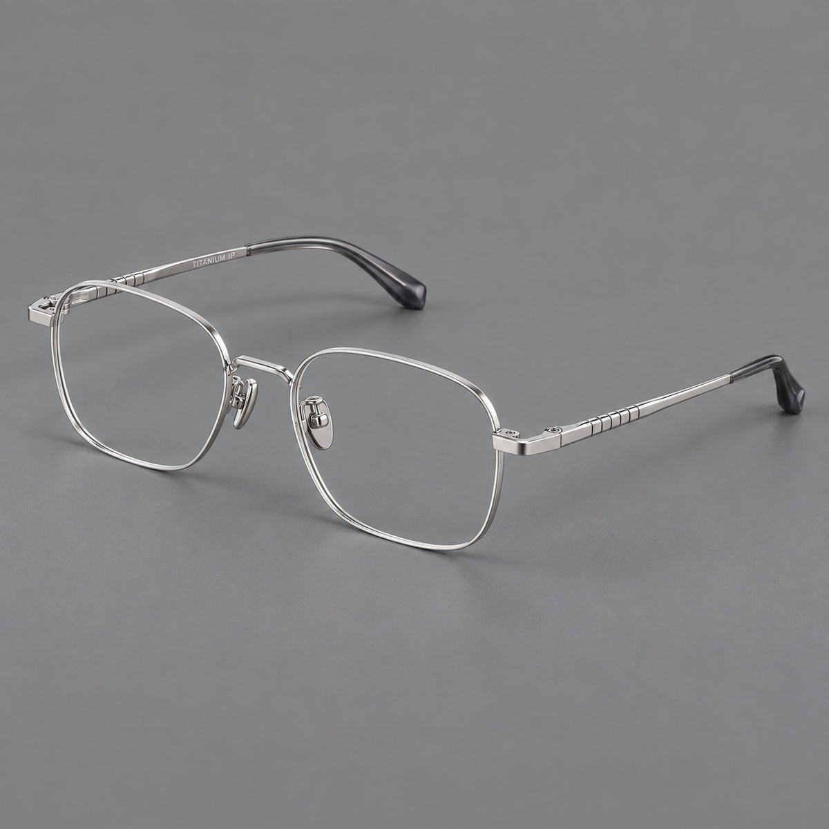 Soft square titanium glasses with a raised bridge and engraved temple bands in Silver, three quarter view