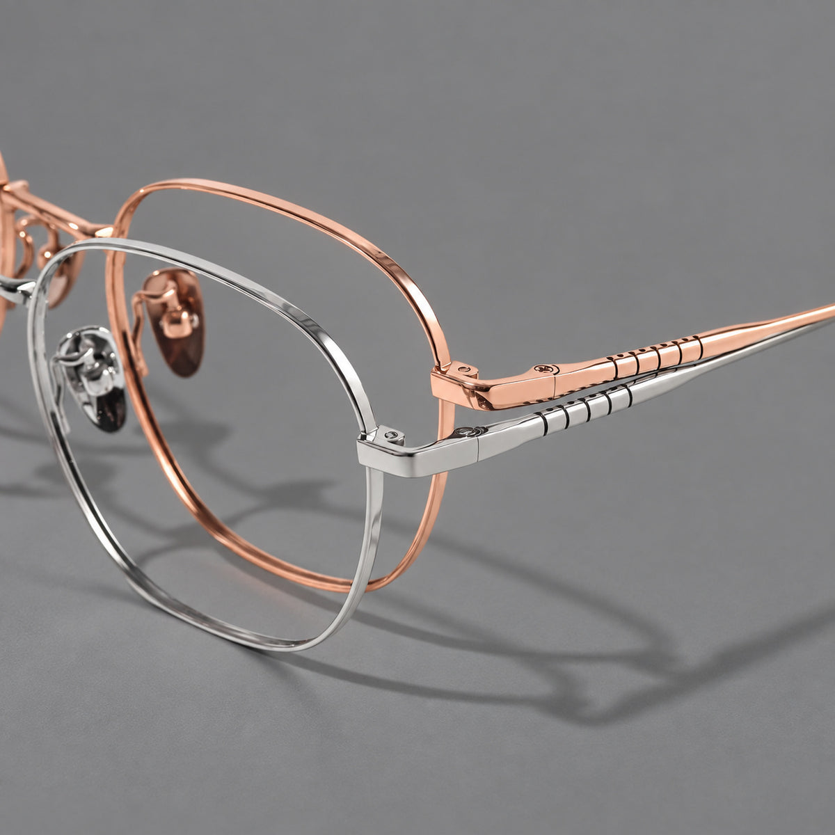 Soft square titanium glasses with a raised bridge and engraved temple bands, frame details