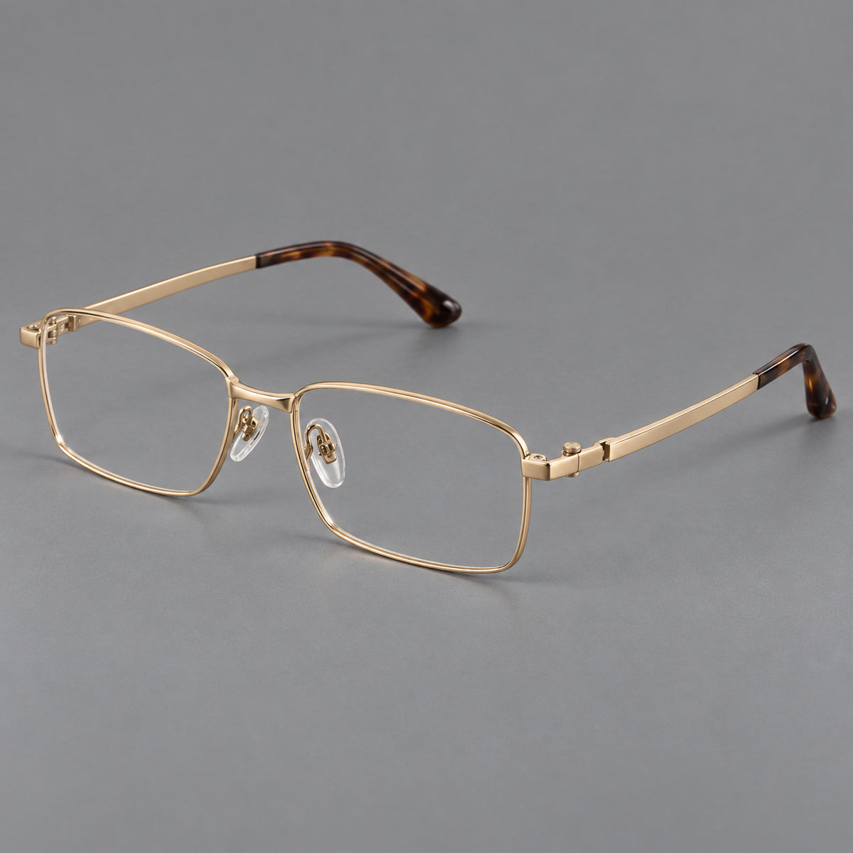 Wide rectangular titanium glasses with a broad bridge and rounded hinge caps in Gold, three quarter view