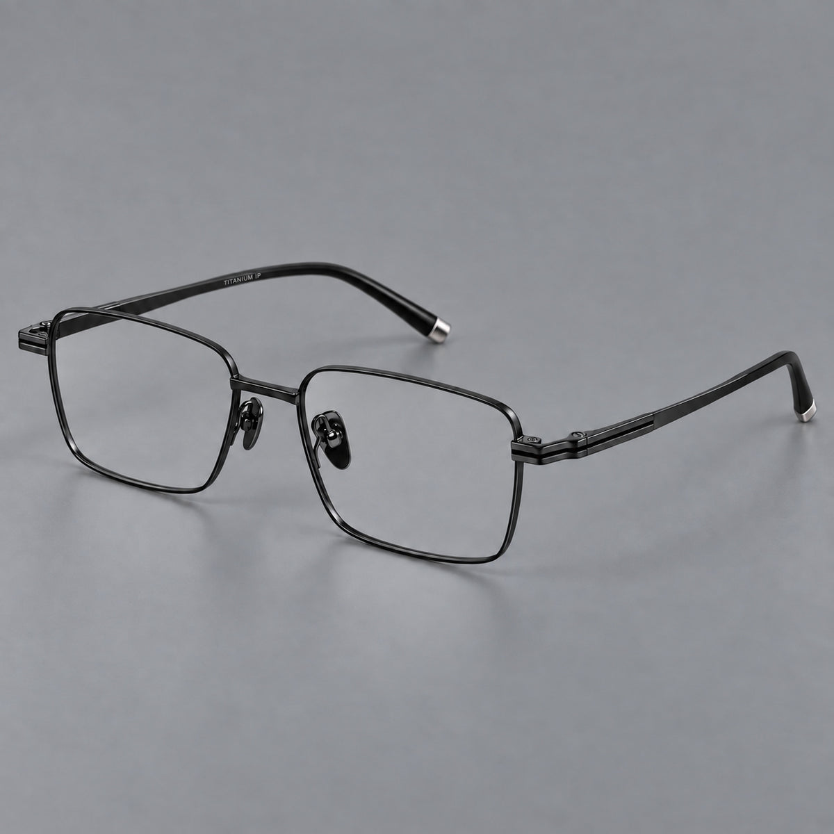 Rectangular titanium glasses with inset corner lines and metal capped temple tips in Black, three quarter view