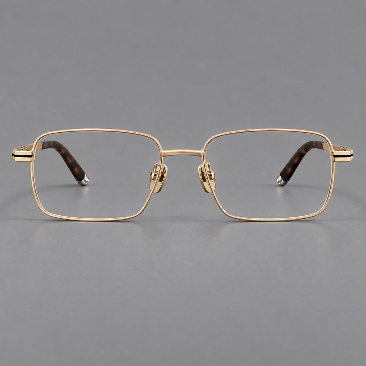 Rectangular titanium glasses with inset corner lines and metal capped temple tips in Gold, front view