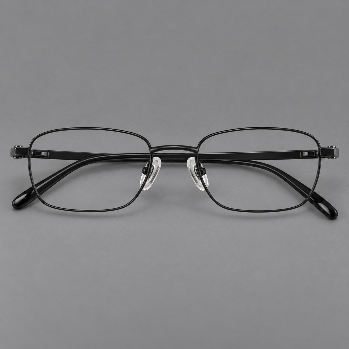 Shallow rectangular titanium glasses with a broad bridge and stepped temple joins in Black, front view