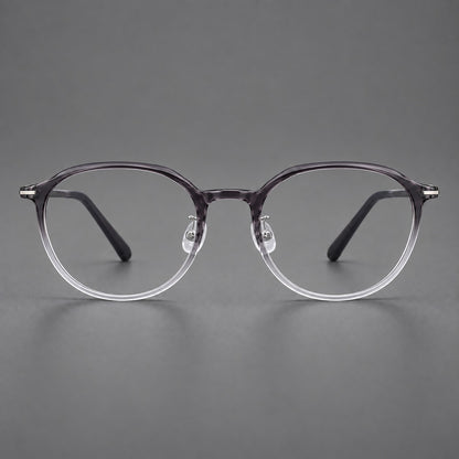 Retro round plastic eyeglasses with a curved bridge and slim metal corner accents in Ink Grey Gradient, front view frame detail