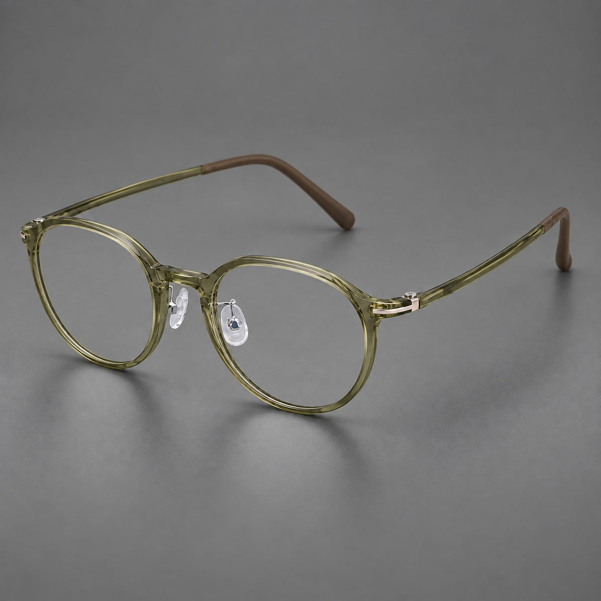 Compact round plastic eyeglasses with gently lifted corners and clear nose pads in Iced Green Tea, three quarter view