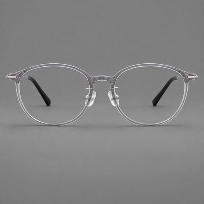Slim oval plastic eyeglasses with a low profile and subtle metal corner accents in Clear Grey, front view frame detail