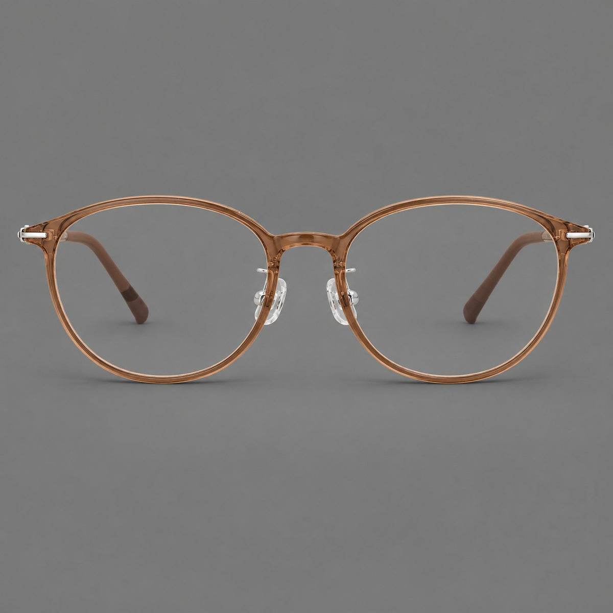 Slim oval plastic eyeglasses with a low profile and subtle metal corner accents in Honey Tea, front view