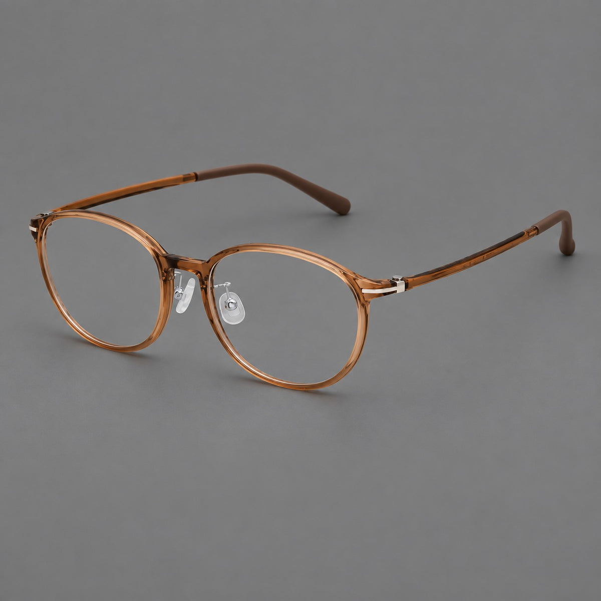 Slim oval plastic eyeglasses with a low profile and subtle metal corner accents in Honey Tea, three quarter view
