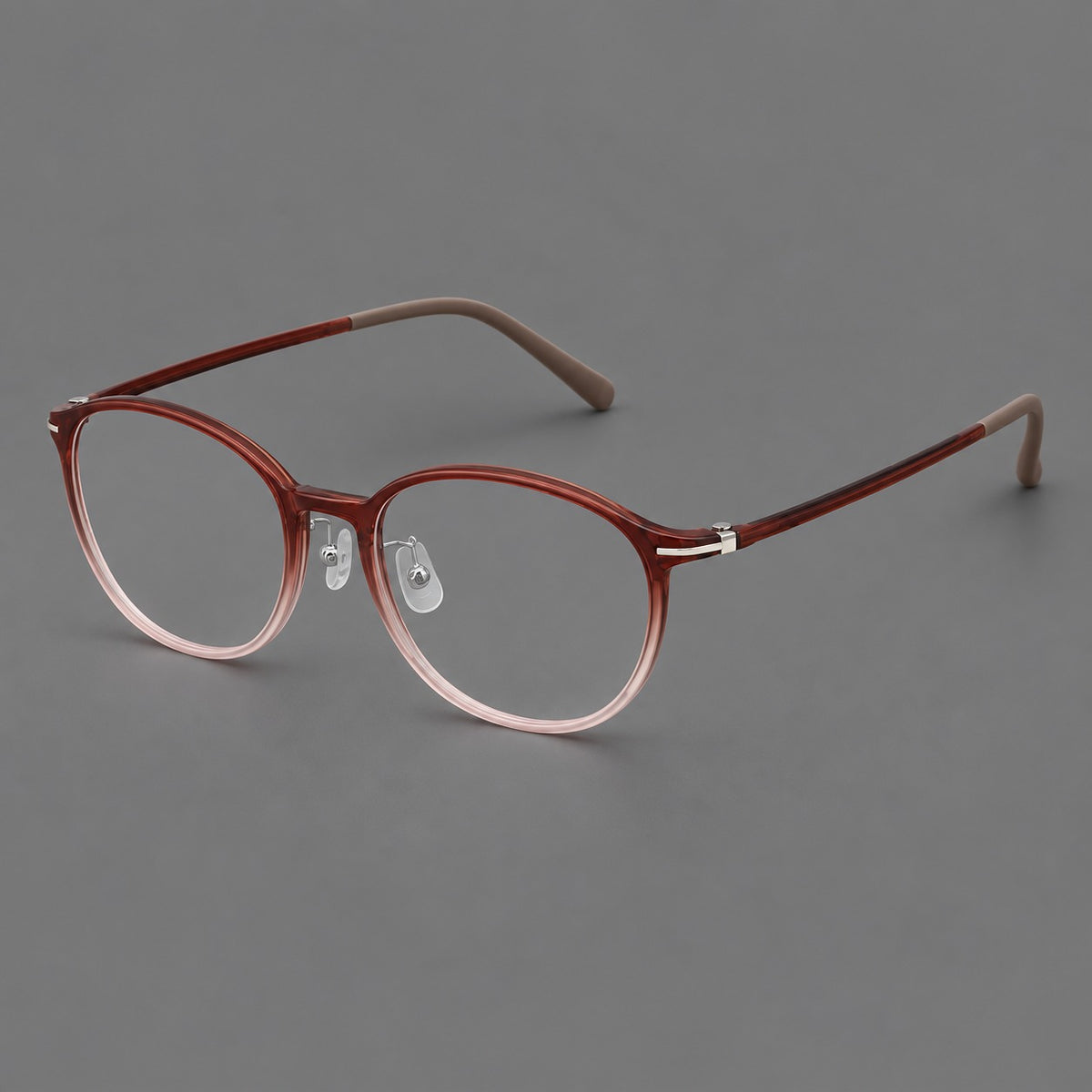 Slim oval plastic eyeglasses with a low profile and subtle metal corner accents in Red Brown Gradient, three quarter view