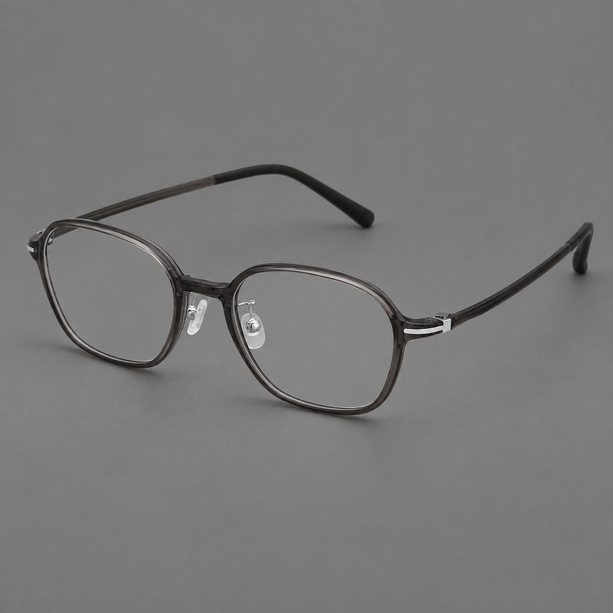 Rounded geometric plastic eyeglasses with softly angled rims and a curved bridge in Dark Grey, three quarter view